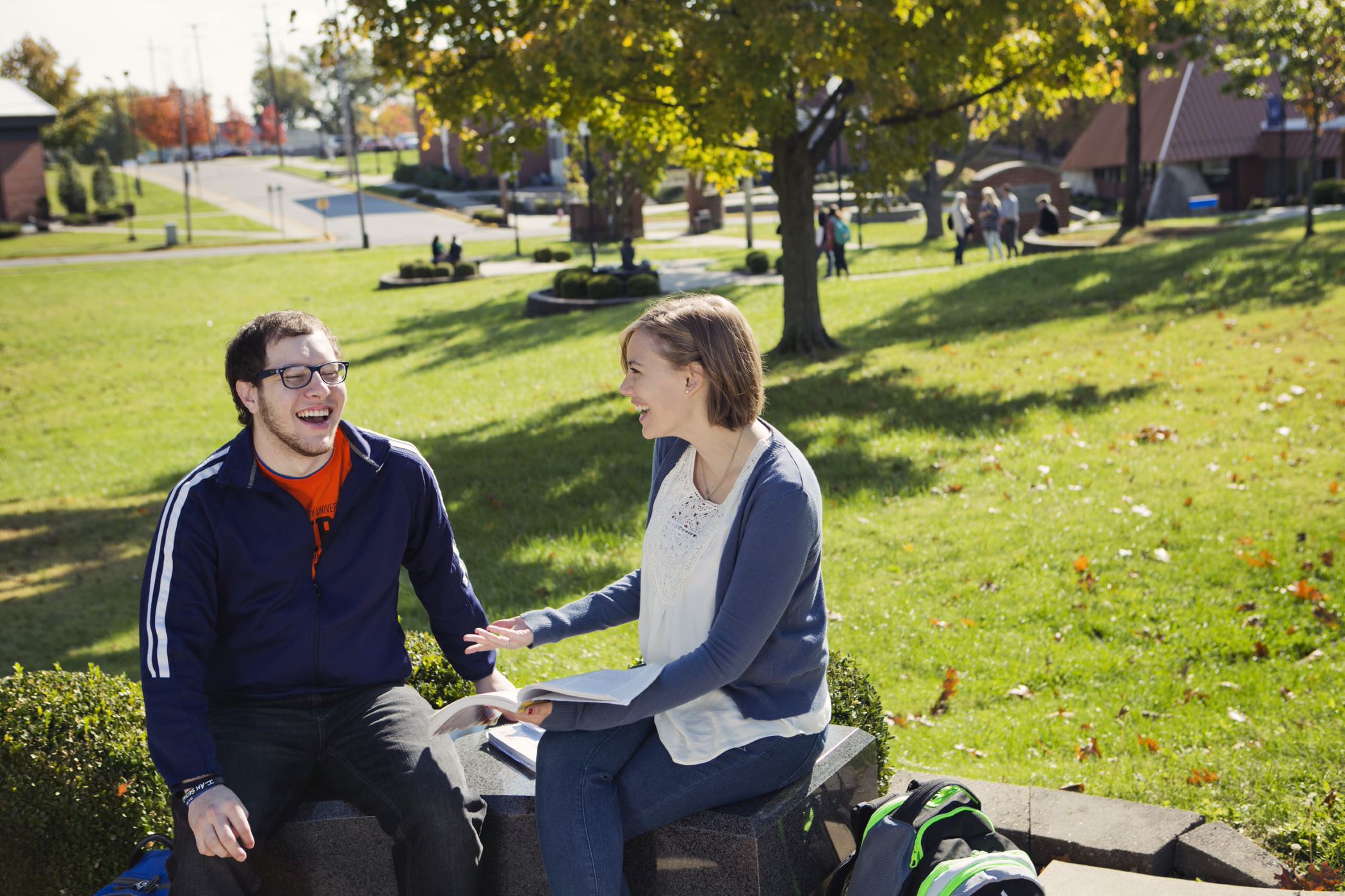 Two students laughing on campus